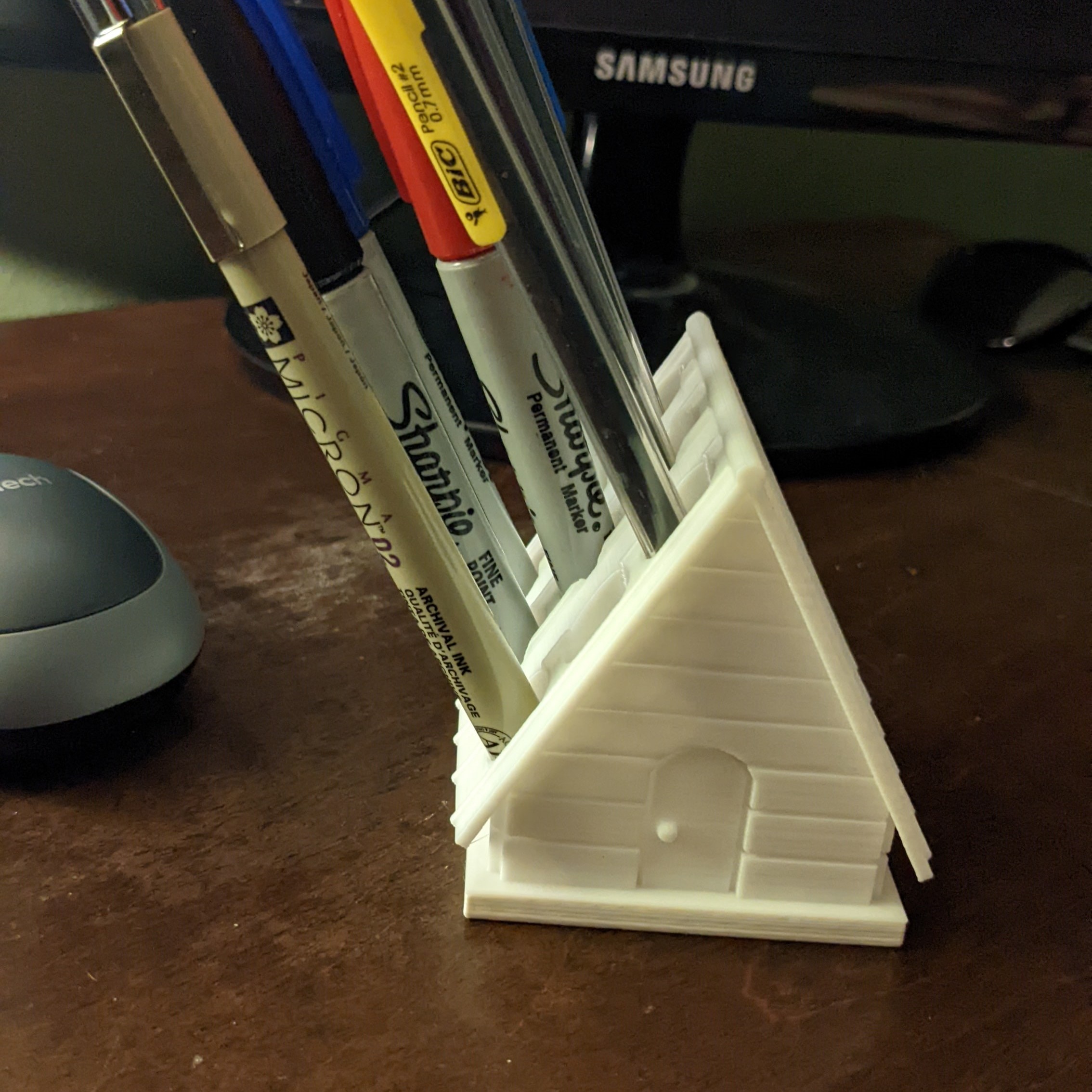 Holder with a few pens and pencils